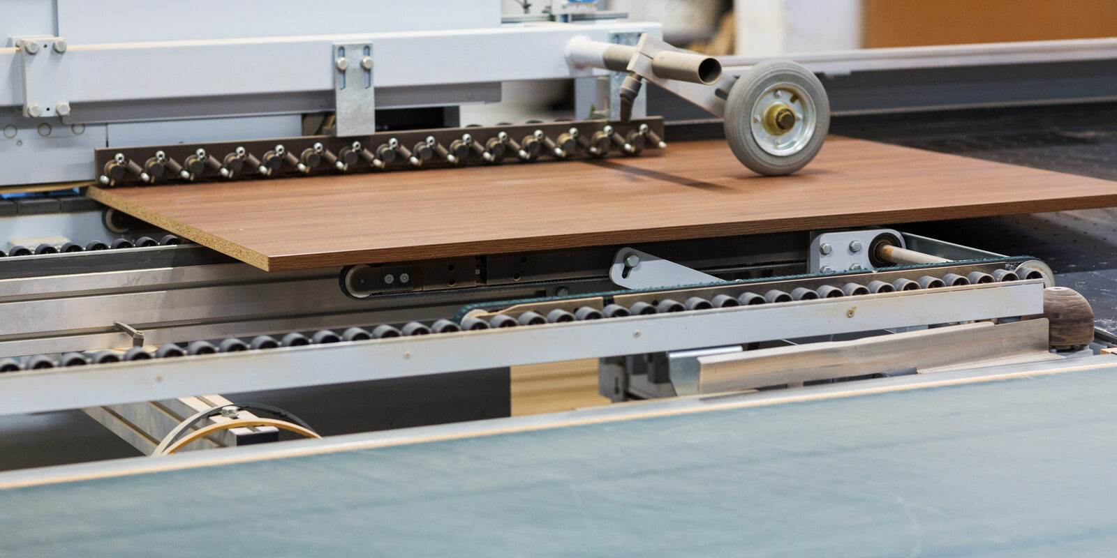 production, manufacture and woodworking industry concept - chipboards processing on conveyer at furniture factory workshop